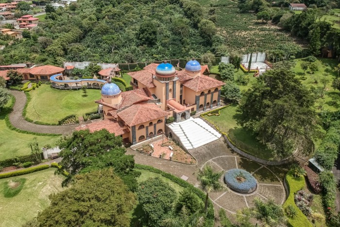 A villa with striking features, such as its three domes, stained-glass windows and aqueduct