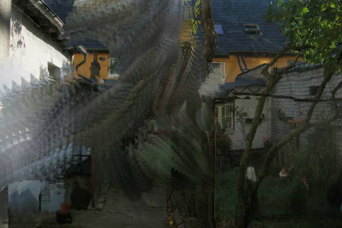 A photo of a house from behind digitally distorted