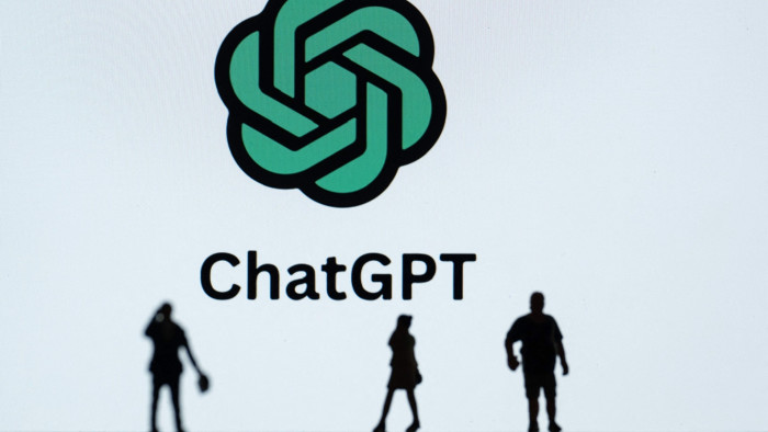 Shadows of people in front of a ChatGPT logo 