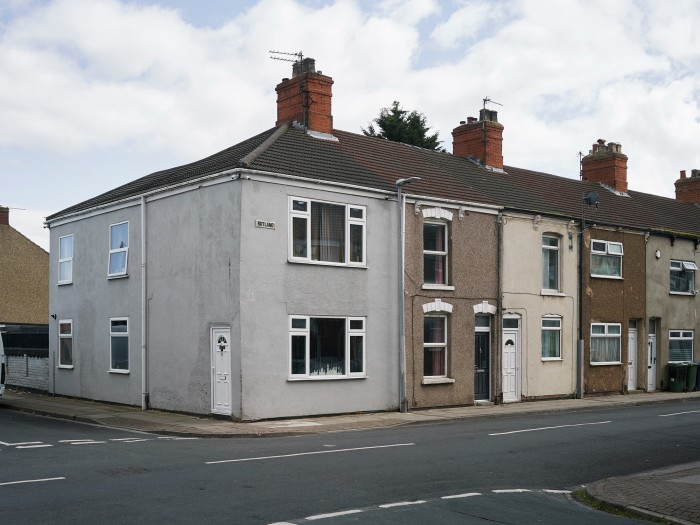 A row of terraced housing with a street sign on the end house saying ‘Rutland’