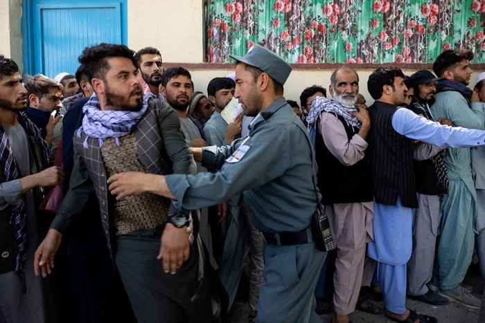 Afghans forming lengthy queues at a passport office in Kabul on August 14, as the Taliban close in on the capital after taking Herat, Mazar-i-Sharif and the country’s second-largest city, Kandahar