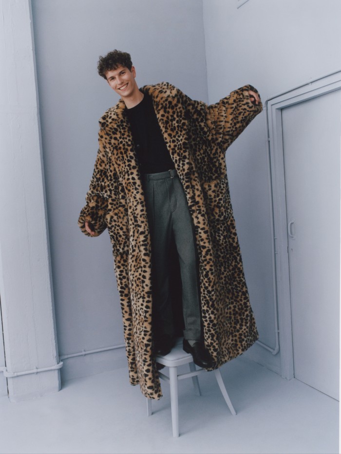 Dolce & Gabbana eco-fur coat, £4,400. Sunspel merino cardigan, £350, and cotton T-shirt, £80. Officine Générale wool trousers, £275. Pantherella cotton socks, £14. John Lobb leather shoes, £1,075
