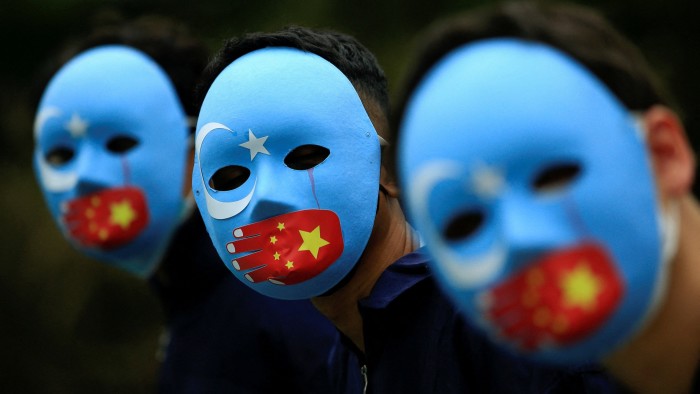 Activists take part in a protest against China’s treatment towards the ethnic Uyghur people