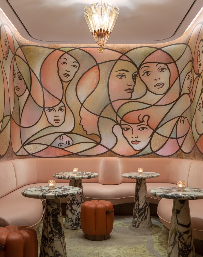 An inlaid mural and pink leather banquette in the snug