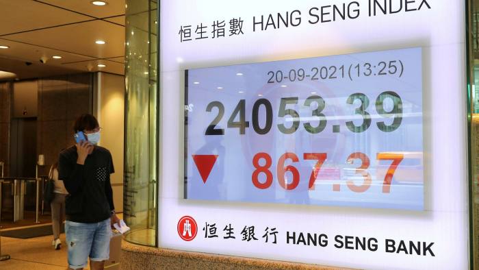 An electronic screen displays the Hang Seng index in Hong Kong