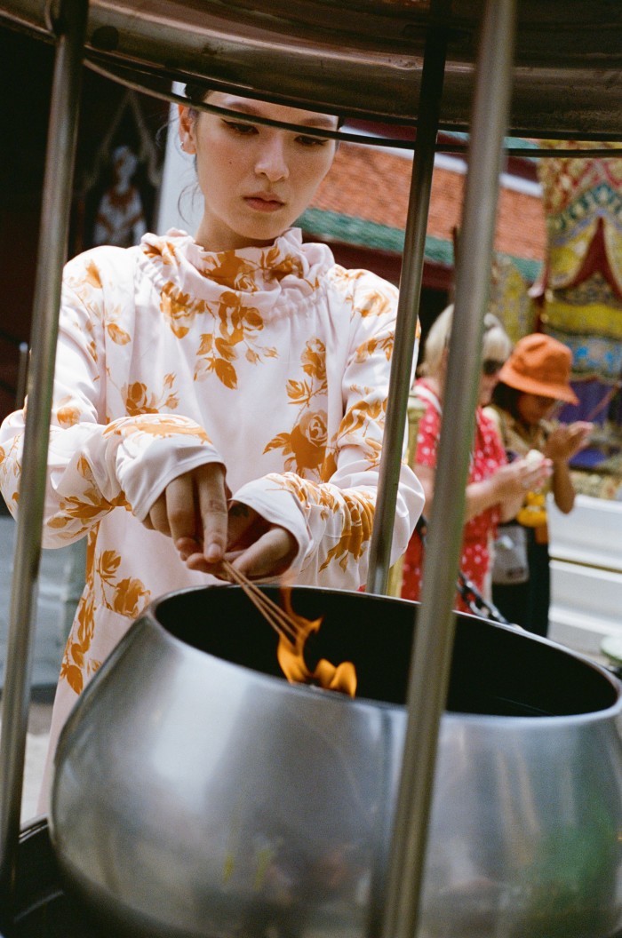 Christine wears Jil Sander by Lucie and Luke Meier silk-mix dress, POA. Wat Arun temple