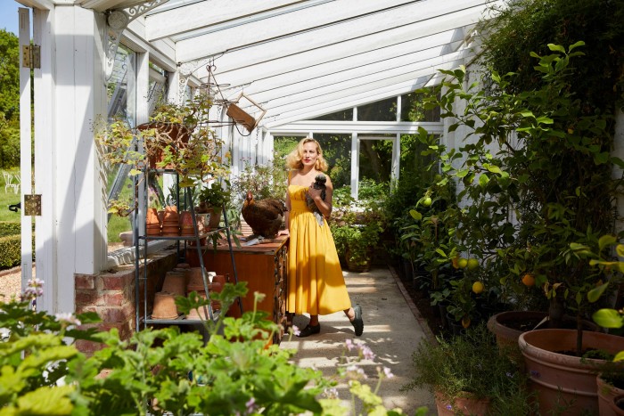 Dellal with two of her 11 chickens in her greenhouse
