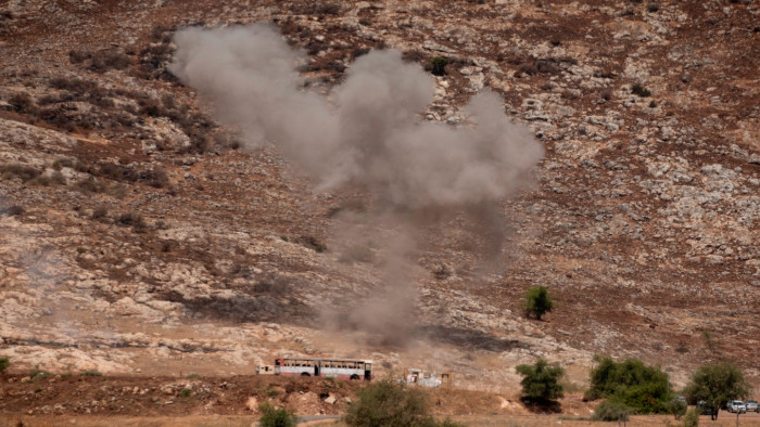 Smoke rises after a rocket fired from Lebanon lands close to a military base in northern Israel