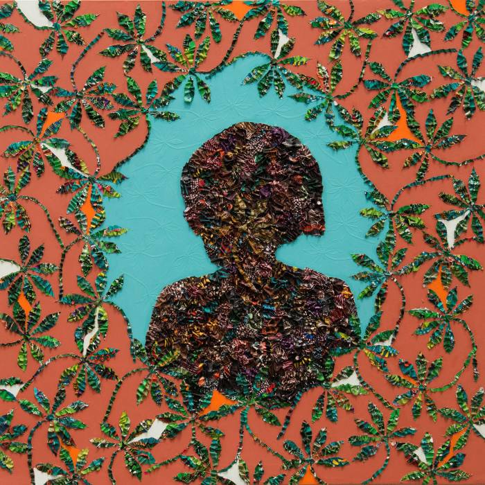 Silhouette head of a person in a frame of green leaves against an orange background