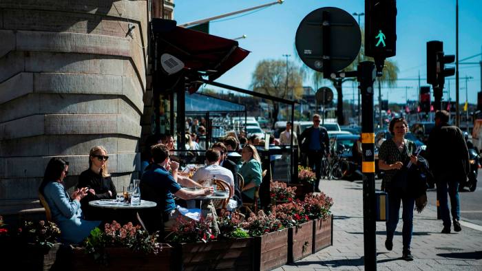 People have lunch at a restaurant in Stockholm during the coronavirus pandemic