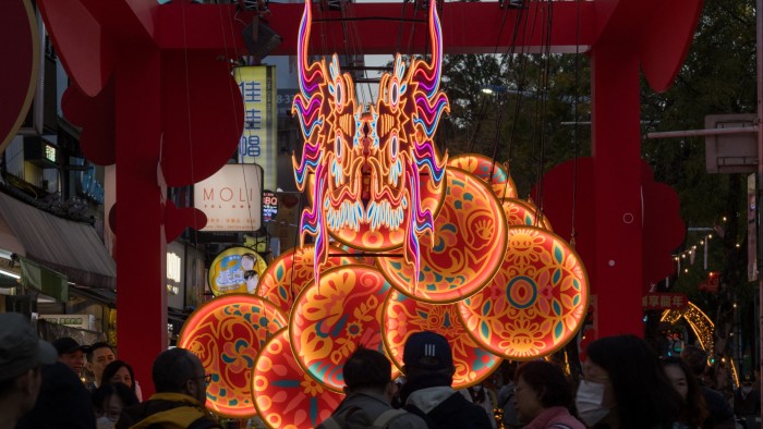 People looks at a dragon-shaped installation at the Ximen District in Taipei