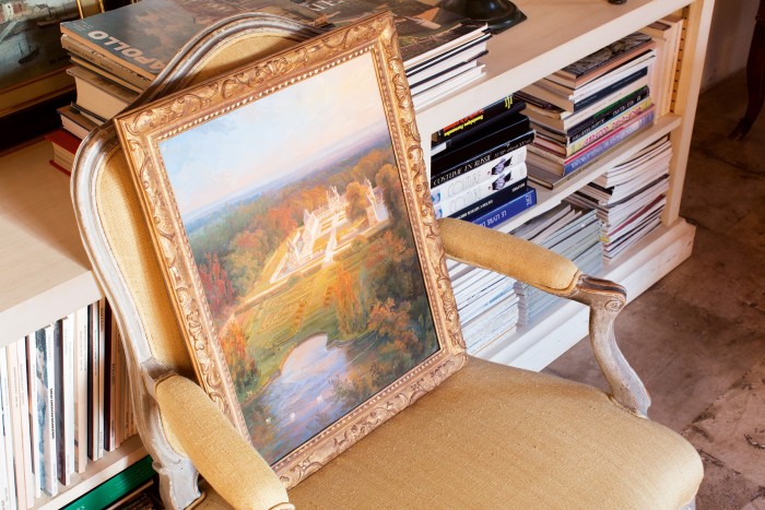 A Louis XV chair with a painting of the manor