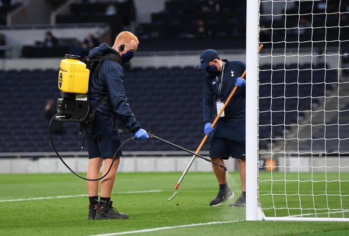 Ground staff disinfect one of the goals during the Spurs vs Man Utd game. To get on the pitch, people must adhere to a set of protocols that are far stricter than anything faced by thousands of other UK staff returning to work after lockdown