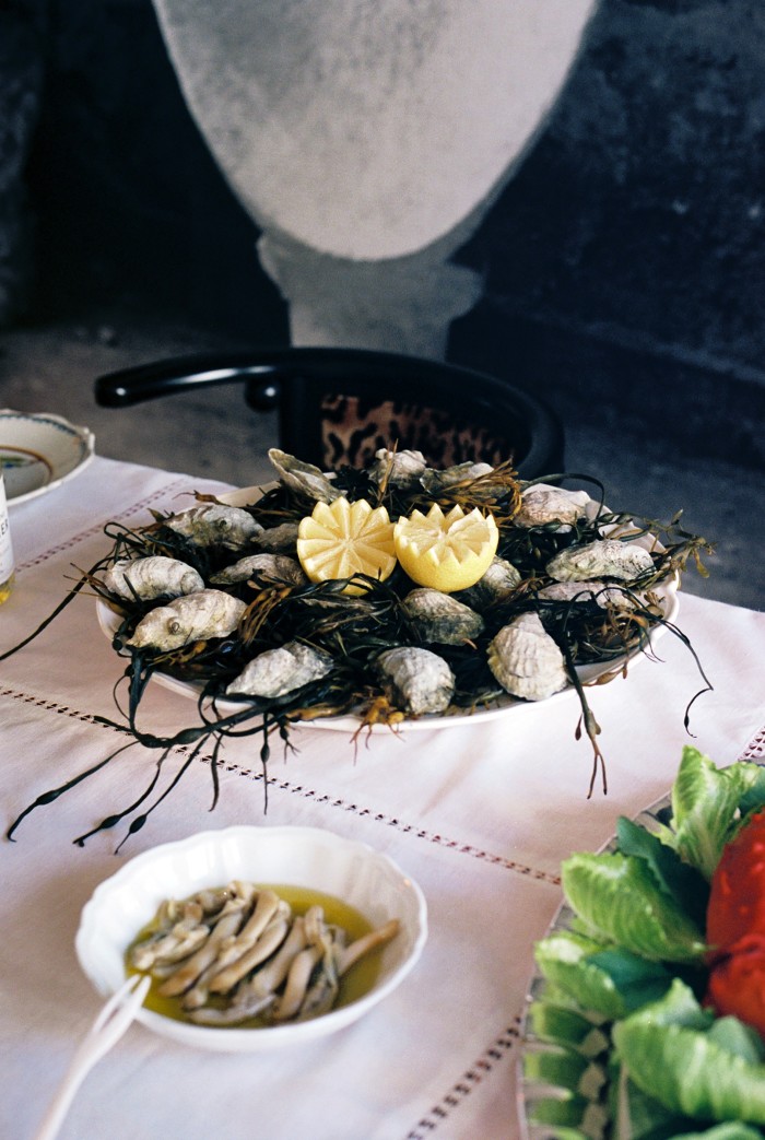 A platter of fresh oysters and a dish of razor clams