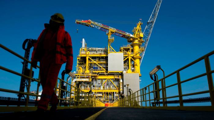 An employee walks along the Total platform on the North Sea over the Culzean gas field