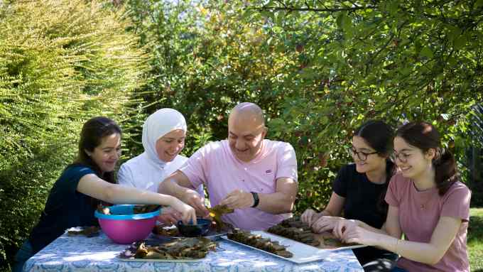 A family stuffing vine leaves together