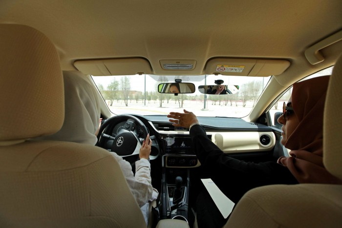An instructor guides her trainee at a driving school for women in Dhahran