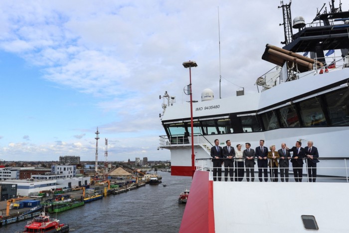 EU leaders on the viewing deck of a ship, standing side by side, having a conversation