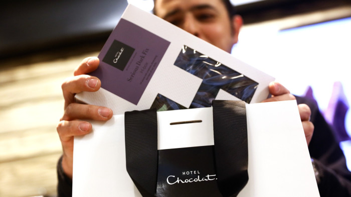 A customer is served at a branch of Hotel Chocolat