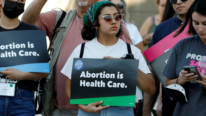 A woman holds an ‘Abortion is health care’ during a rally outside a Las Vegas courthouse