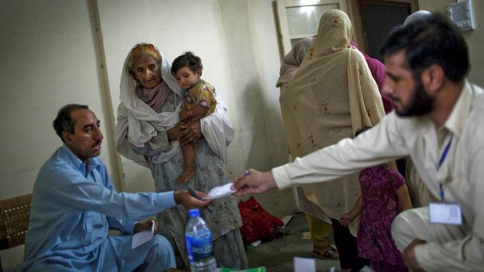 Medical personnel distribute antibiotics at a makeshift hospital in Pakistan