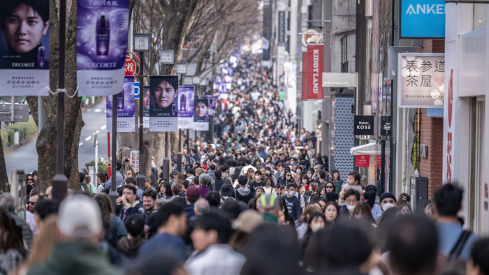 People walk through Omotesando shopping street in Tokyo 