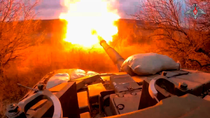 A Russian tank fires at Ukrainian troops from near the border with Ukraine in Russia’s Belgorod region