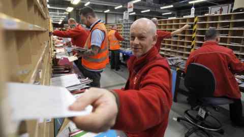 Workers sort mail at the Royal Mail Distribution centre in Glasgow in what is traditionally the busiest day of the year for mail in the run up to Christmas on December 15, 2016. / AFP PHOTO / Andy BuchananANDY BUCHANAN/AFP/Getty Images