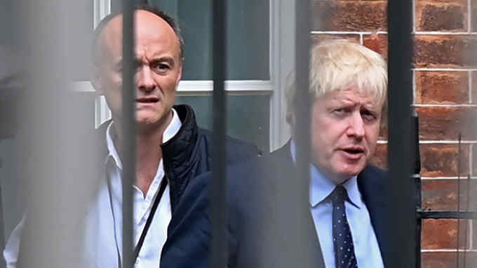 Britain's Prime Minister Boris Johnson (R) and his special advisor Dominic Cummings leave from the rear of Downing Street in central London on September 3, 2019, before heading to the Houses of Parliament. - The fate of Brexit hung in the balance on Tuesday as parliament prepared for an explosive showdown with Prime Minister Boris Johnson that could end in a snap election. Members of Johnson's own Conservative party are preparing to join opposition lawmakers in a vote to try to force a delay to Britain's exit from the European Union if he cannot secure a divorce deal with Brussels in the next few weeks. (Photo by DANIEL LEAL-OLIVAS / AFP)DANIEL LEAL-OLIVAS/AFP/Getty Images