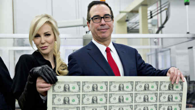 Steven Mnuchin, U.S. Treasury secretary, right, and his wife Louise Linton hold a 2017 50 subject uncut sheet of $1 dollar notes bearing Mnuchin's name for a photograph at the U.S. Bureau of Engraving and Printing in Washington, D.C., U.S., on Wednesday, Nov. 15, 2017. A change in the Senate tax-overhaul plan that would expand a temporary income-tax break for partnerships, limited liability companies and other so-called &quot;pass-through&quot; businesses won the endorsement of a national small-business group today. Photographer: Andrew Harrer/Bloomberg