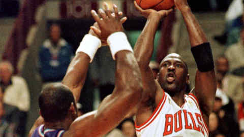 FILE PHOTO: ON THIS DAY -- June 4 June 4, 1997 BASKETBALL - Chicago Bulls' Michael Jordan shoots over Utah JazzÕs Karl Malone during the first period of the second game of the NBA Finals at the United Center, Chicago. Jordan put up 38 points, 13 rebounds and nine assists to help the Bulls pick up a 97-85 win and take a 2-0 lead in the series, having eked out a two-point victory in Game 1. REUTERS/Sue Ogrocki/File photo