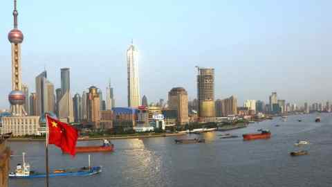 The Pudong financial district is seen from across the Huang Pu river, in Shanghai, China in October, 2002.  Photographer: Dermot Tatlow/ Bloomberg News.