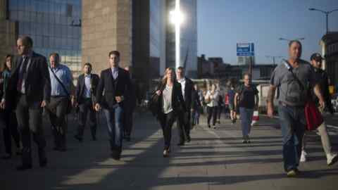 City commuters make their way over London Bridge this morning.