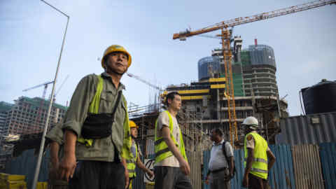 COLOMBO, SRI LANKA - NOVEMBER 10: Chinese Construction workers head home after work on site at a new shopping mall called The Mall at One Galle Face which is part of the Chinese managed Shangri-La retails and office complex on November 10, 2018 in Colombo, Sri Lanka. In just a few years Port City will be the site of tall glass skyscrapers, a busy financial district, hospitals, hotels and even a theme park. As the political crisis escalates in Sri Lanka, former President Mahinda Rajapaksa&quot;u2019s return to power in late October has been watched with increasing concern by countries including the U.S., China and India. The re-entry of Rajapaksa could and raise the influence from Beijing and alter the power dynamics around the Indian Ocean. During Rajapaksa&quot;u2019s 2005-2015 presidency, Sri Lanka saw an influx of Chinese investment and economic support since he relied heavily on China for economic support, military equipment and political cover. While ousted Prime Minister Ranil Wickremesinghe sought to balance relations with New Delhi and Beijing, Rajapaksa made clear his willingness to accept Chinese money even in the face of unreasonable terms while reports from the Central Bank estimated the debt owed to China could be as much as $5 billion and growing every year. Chinese investments paid for a new port, a new airport and new railway on Sri Lanka&quot;u2019s southern coast, among other projects in Colombo, which forced the government to sell strategic assets to Beijing, such as the Hambantota port, when it wasn't able to meet liabilities. For China, the relation with Sri Lanka ties back thousands of years when it was a stop along the old Silk Road trade routes, as it is now known to be a critical link for its Belt and Road Initiative, which aims to expand trade across 65 countries from the South Pacific through Asia to Africa and Europe. (Photo by Paula Bronstein/Getty Images)
