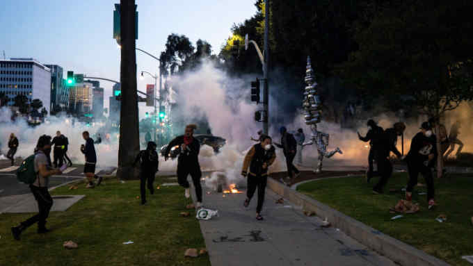 Mandatory Credit: Photo by ETIENNE LAURENT/EPA-EFE/Shutterstock (10664481j) Protesters flee tear gas as they face the police next to Rodeo Drive during curfew as thousands of protesters take the street to demonstrate following the death of George Floyd, in Beverly Hills, California, USA, 30 May 2020. A bystander's video posted online on 25 May appeared to show George Floyd, 46, pleading with arresting officers that he couldn't breathe as an officer knelt on his neck, in Minnesota. The unarmed black man later died in police custody. Black Lives Matter protest in Los Angeles after fatal arrest in Minnesota, Beverly Hills, USA - 30 May 2020