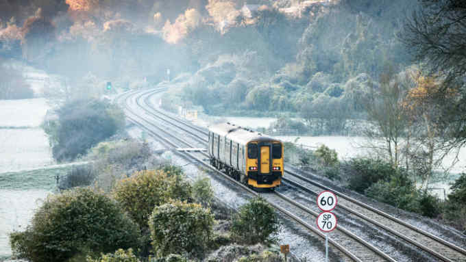 BATH, ENGLAND - NOVEMBER 13: A train passes near to the as frost lingers on the tracks near the Dundas Aqueduct as the sun rises on November 13, 2017 near Bath, England. After a warm autumn, with temperatures above average, much colder weather has arrived in many parts of the UK, signalling the start of more wintery weather for the coming few weeks. (Photo by Matt Cardy/Getty Images)