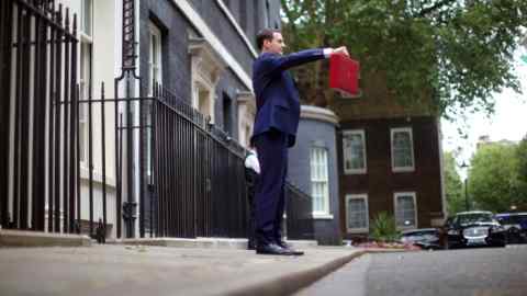 Chancellor George Osborne, leaves Downing street to deliver the budget