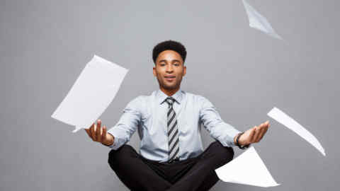M8YFPA Business Concept - handsome young professional african american businessman throwing away pile of paperworks flying on air.