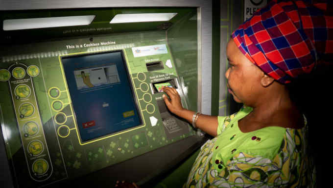 A woman at a self-service ATM-style machine at the Themba Lethu Clinic in Johannesburg PHOTO CREDIT - Bridget Corke
