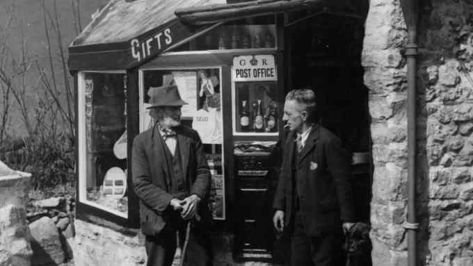 20th April 1936:  Postmaster William Hubbard, who built Ashopton post office single handedly from local stone, discussing its impending doom with a villager. The area will disappear under the Derwent Valley reservoir scheme in less than four years.  (Photo by Fox Photos/Getty Images)