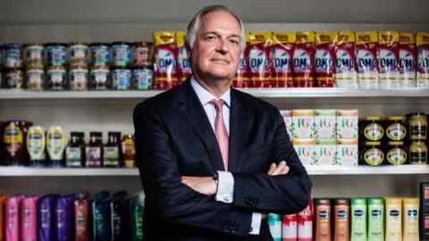 Paul Polman, chief executive officer of Unilever NV, poses for a photograph with a selection of Unilever products at their headquarters in London, U.K., on Wednesday, Aug. 24, 2016. Unilever manufactures branded and packaged consumer goods, including food, detergents, fragrances, home, and personal care products. Photographer: Simon Dawson/Bloomberg