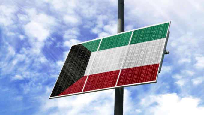 TATCTR Solar panels against a blue sky with a picture of the flag of Kuwait