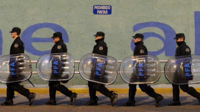 Argentine policemen are deployed along the Pueyrredon bridge blocked by demonstrators of leftist parties in Buenos Aires on June 9, 2015, during a strike in Argentina.