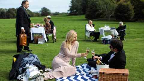 LEWES, ENGLAND - AUGUST 04: Visitors hold picnics in the grounds of Glyndebourne opera house before a production of La Traviata on August 04, 2017 in Lewes, England. The Season in Britain today loosely refers to various prestigious social and sporting events held throughout the summer months. The Season originated in the 17th century and was a way for the elite and aristocratic youth to be introduced to one another and launched into society. In recent years, events which make up the Season have become increasingly corporate and less exclusive. (Photo by Jack Taylor/Getty Images)