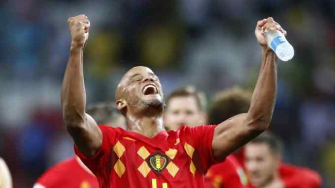 Belgium's Vincent Kompany celebrates towards his teams supporters after defeating Brazil in their quarterfinal match between Brazil and Belgium at the 2018 soccer World Cup in the Kazan Arena, in Kazan, Russia, Friday, July 6, 2018. (AP Photo/Matthias Schrader)