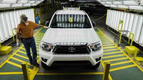 A worker performs a round of quality control checks on a Toyota Motor Corp. Tacoma truck at the company's manufacturing facility in San Antonio, Texas, U.S., on Monday, March 24, 2014. Toyota Motor Corp. will consider investments that can increase production efficiently and doesn't plan to build new plants in three years from 2013, President Akio Toyoda said in an interview with Nikkei newspaper. Photographer: T.J. Kirkpatrick/Bloomberg