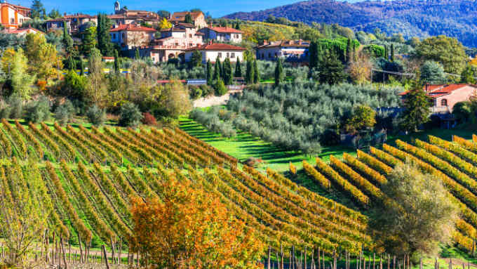 Classical Tuscany landscape - rolling hills and vineyards in autumn colors