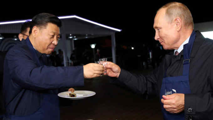 Russian President Vladimir Putin and Chinese President Xi Jinping toast during a visit to the Far East Street exhibition on the sidelines of the Eastern Economic Forum in Vladivostok, Russia September 11, 2018. Sergei Bobylev/TASS Host Photo Agency/Pool via REUTERS TPX IMAGES OF THE DAY