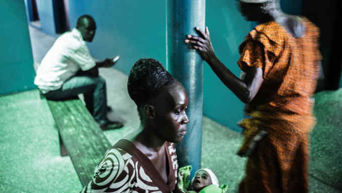 Waiting time: a woman and child at a health centre in Monrovia, Liberia. The country has one of the world’s highest adolescent pregnancy rates