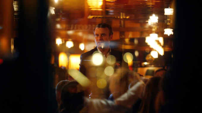 TOPSHOT - French presidential election candidate for the En Marche ! movement Emmanuel Macron looks on
at La Rotonde restaurant in Paris, on April 23, 2017, after the first round of the Presidential election.
Pro-European Emmanuel Macron is set to face far-right candidate Marine Le Pen in France's presidential run-off, results showed on April 24, making him clear favourite to emerge as the country's youngest leader in its history. / AFP PHOTO / GEOFFROY VAN DER HASSELT        (Photo credit should read GEOFFROY VAN DER HASSELT/AFP via Getty Images)